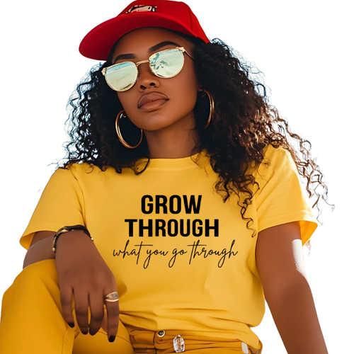 Woman wearing a faith graphic tee with "Grow Through What You Go Through" text, made of soft cotton, relaxed fit by Purposeful Prints
